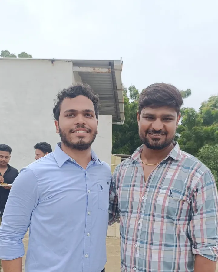 Harshad standing with a member of the Vivekananda team outside the centre after qualifying as a CA