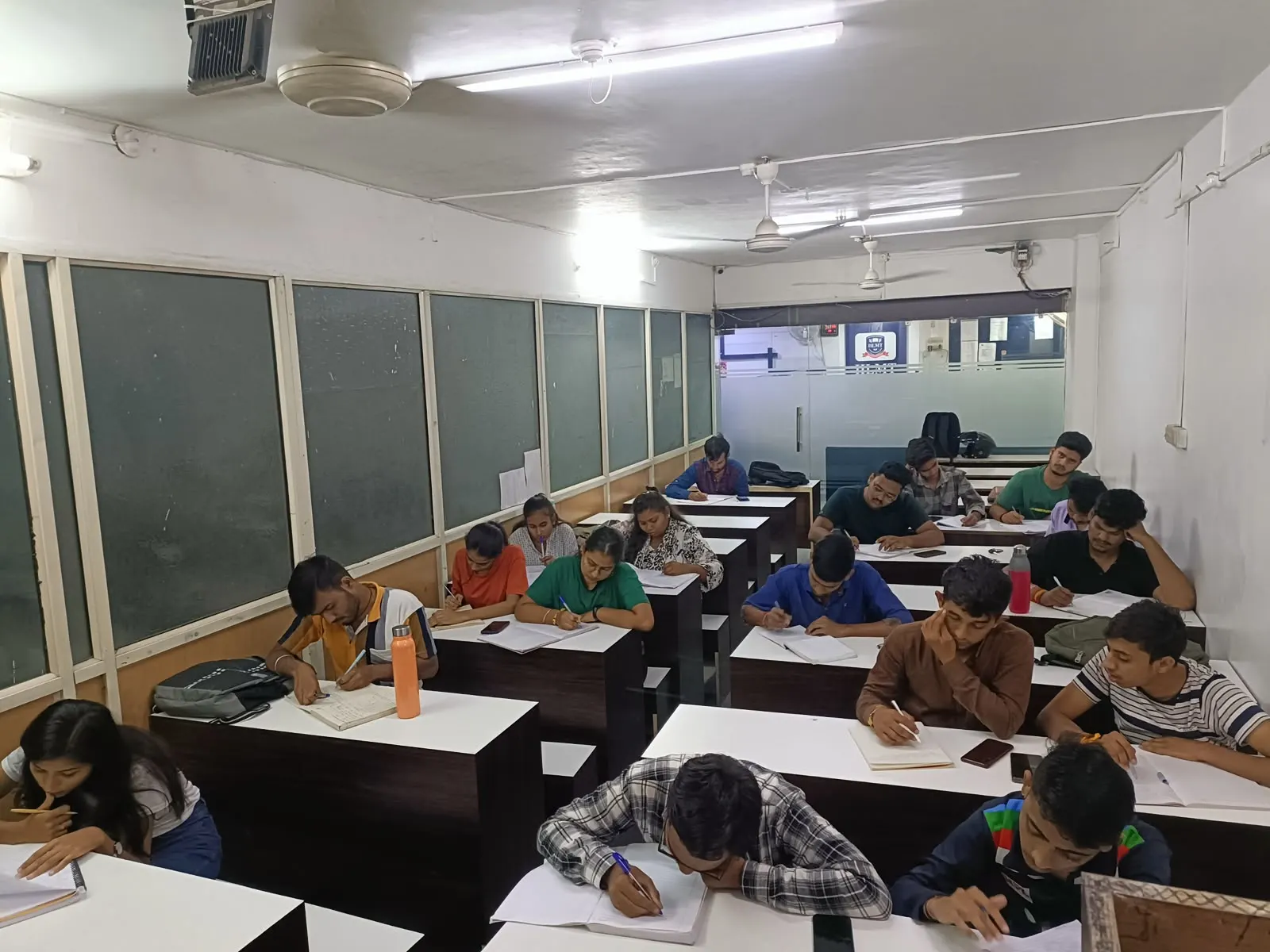 A wider view of the same hall, showing how far back the rows of partitioned desks run